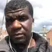 Selfie image of Yves Sakila with ear phone wires hanging from his ears