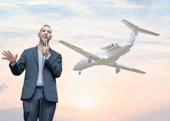 Zack Polanski in front of a private jet