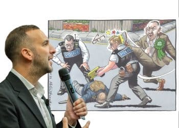 Zack Polanski in front of an antisemitic cartoon