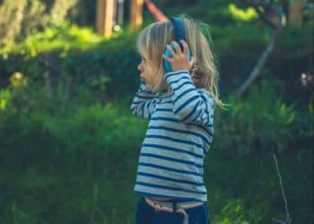 A child wearing ear defenders