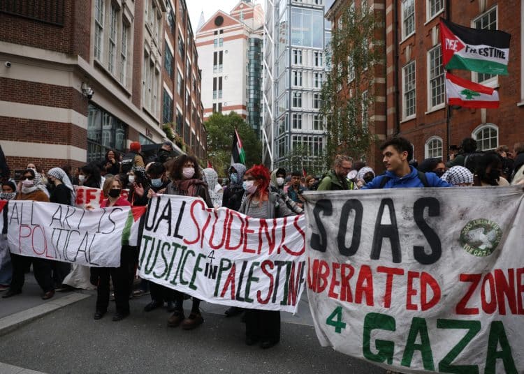 LONDON, ENGLAND - OCTOBER 7: Protesters from a number of London universities attend a pro-Palestine demonstration on October 7, 2025 in London, England. On the same day as people mark the second anniversary of the Hamas attacks on Israel which led to more than 1200 deaths and 251 hostages taken, students from King's College London, London School of Economics, University College London, and School of Oriental and ­African Studies (SOAS) take part in a march through central London to mark two years since 'the beginning of the genocide in Gaza'. This march comes as Home Secretary Shabana Mahmood announced increased police powers at repeat protests, such as those in support of Palestine. (Photo by Dan Kitwood/Getty Images)