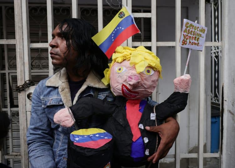 MIRANDA, VENEZUELA - JANUARY 10: A person carries a Donald Trump piñata during a protest in support of Nicolas Maduro at Barrio El Carpintero on January 10, 2026 in Miranda, Venezuela. Maduro and his wife were captured by US forces on the early morning of January 3 in Caracas and later transported to New York. Maduro and Cilia Flores face the US justice, accused of being part of a conspiracy to send drugs to the US. (Photo by Jesus Vargas/Getty Images)