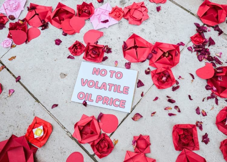 Christian Climate Action against Rosebank with paper roses and a message saying No To Volatile Oil Price