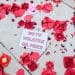 Christian Climate Action against Rosebank with paper roses and a message saying No To Volatile Oil Price