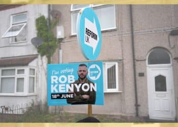 A Reform UK placard of their by-election candidate Robert Kenyon stands outside a terraced home on 3 June 2026 in Ashton-in-Makerfield, England