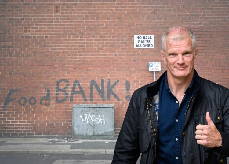 Al Carns in front of a food bank