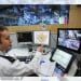 A police officer in front of computers, AI use