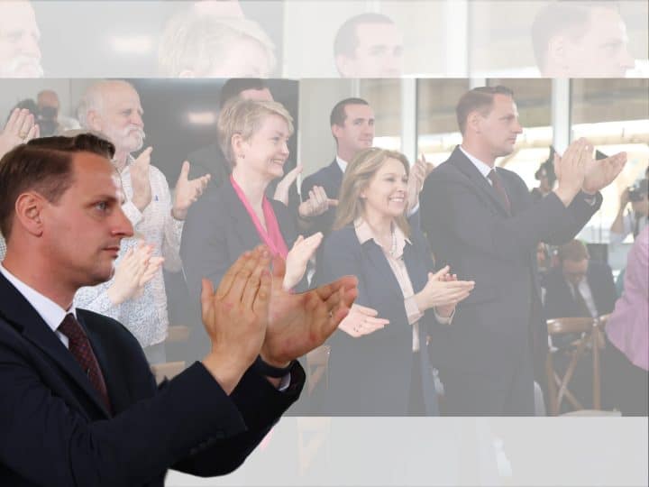 Mike Tapp clapping in front of Yvette Cooper, Labour
