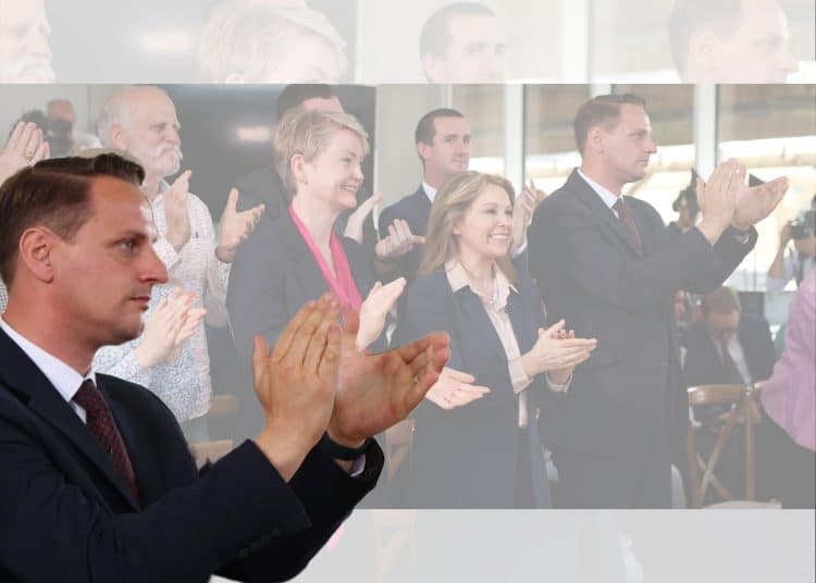 Mike Tapp clapping in front of Yvette Cooper, Labour
