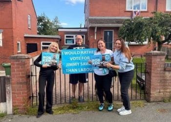 Reform councillors standing next to a man holding a sign which reads 'I would rather vote for Jimmy Saville than Labour'