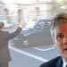 Keir Starmer in front of an image of a tax being hailed