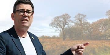 Andy Burnham in front of an image of a field