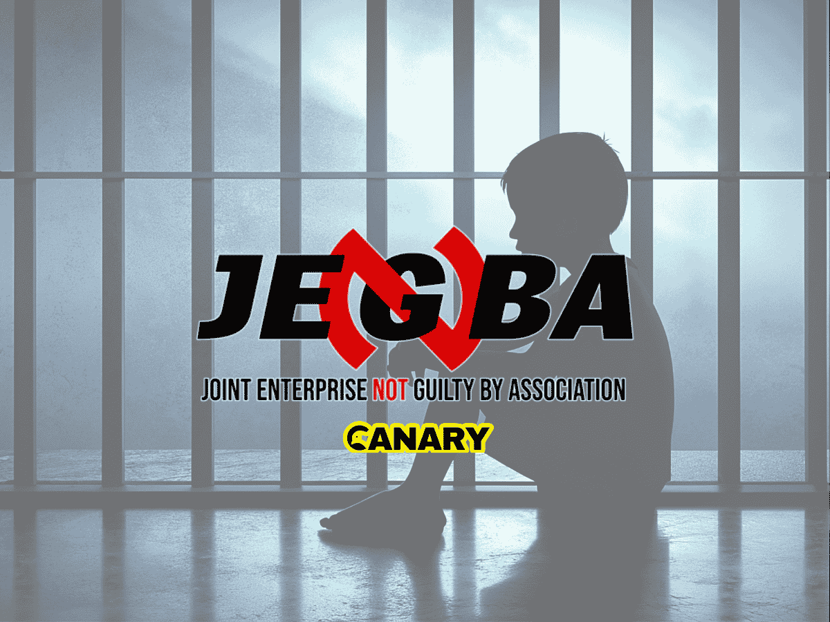 In the backgrounds is an image of a child in prison. It is the silhouette of a child facing left and they have their knees up to their chest. In the forefront is the JENGbA logo and underneath is the Canary UK logo