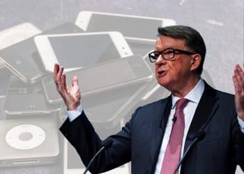 Peter Mandelson in front of pictures of mobile devices