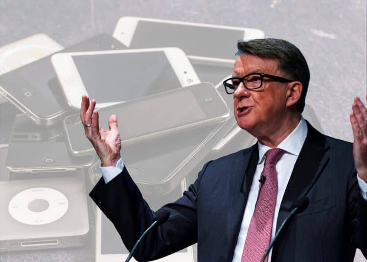 Peter Mandelson in front of pictures of mobile devices