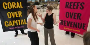 Boycott Bloody Insurance activists in the lobby of the Walkie Talkie. Banners say: Coral Over Capital and Reefs Over Revenue