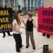 Boycott Bloody Insurance activists in the lobby of the Walkie Talkie. Banners say: Coral Over Capital and Reefs Over Revenue