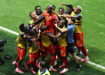 DR Congo celebrates taking the lead over Uzbekistan with a group huddle on the pitch
