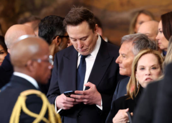 Elon Musk checks phone