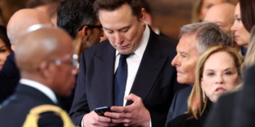 Elon Musk checks phone