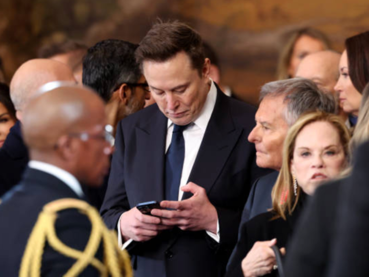 Elon Musk checks phone