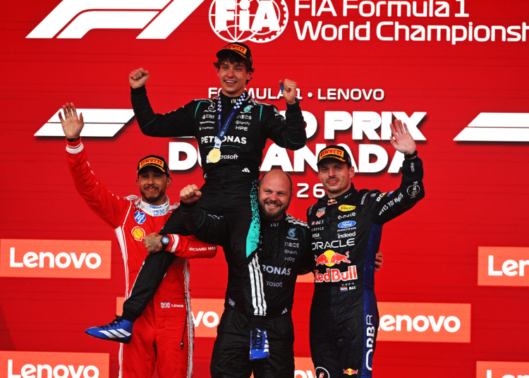 MONTREAL, QUEBEC - MAY 24: Race winner Andrea Kimi Antonelli of Italy and Mercedes AMG Petronas F1 Team Second placed Lewis Hamilton of Great Britain and Scuderia Ferrari Third placed Max Verstappen of the Netherlands and Oracle Red Bull Racing and Dean Hale, Senior Race Team Composite Technician at Mercedes AMG Petronas F1 Team on the podium during the F1 Grand Prix of Canada at Circuit Gilles-Villeneuve on May 24, 2026 in Montreal, Quebec. (Photo by Rudy Carezzevoli/Getty Images) Formula 1