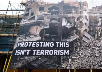 Huge banner shows destruction in Gaza and says: Protesting This Isn't Terrorism Palestine Action