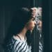 Stock image of girl looking through window, illustrating mental health outcomes