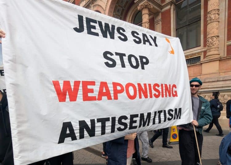 Banner saying Jews Say Stop Weaponising Antisemitism Criticism of Israel is not antisemitic