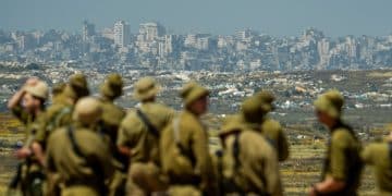 IOF soldiers looking at destroyed town of Jabalia in Gaza