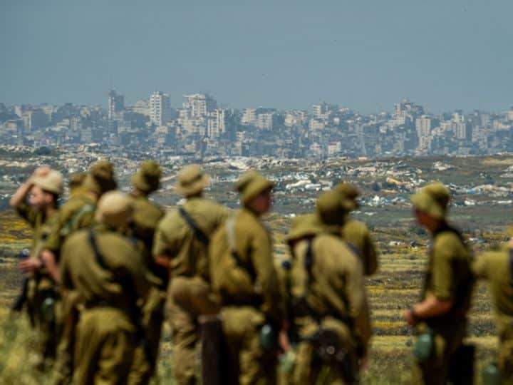 IOF soldiers looking at destroyed town of Jabalia in Gaza