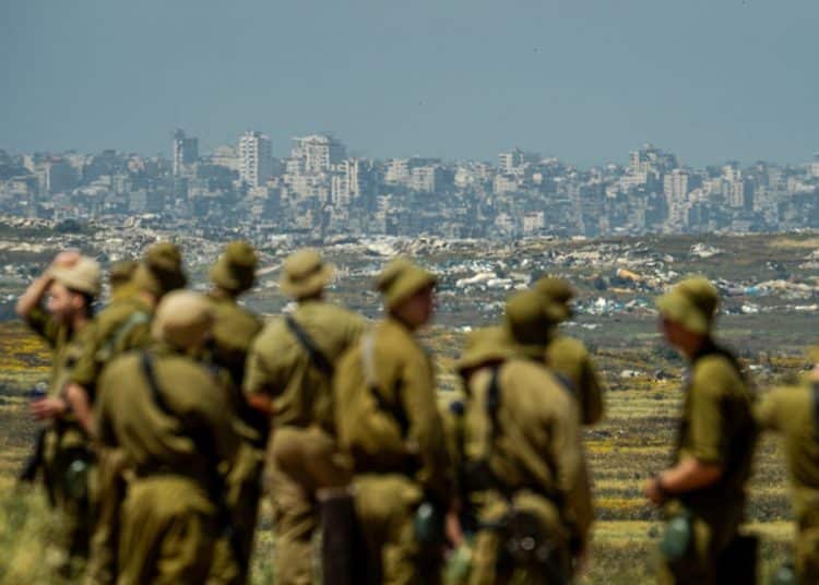 IOF soldiers looking at destroyed town of Jabalia in Gaza
