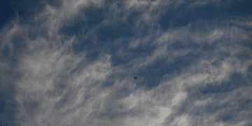 An Israeli air-force single isolated drone in the distance with partly cloudy background. This is not a photo of Israel's AI killer drones in the story.