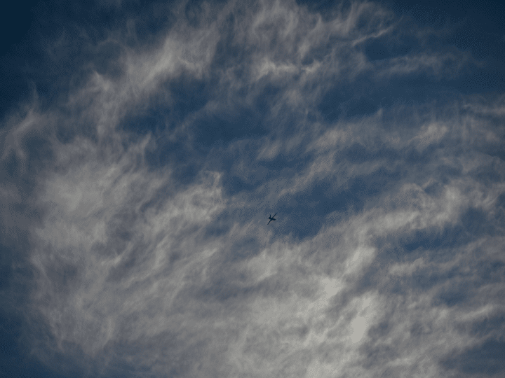 An Israeli air-force single isolated drone in the distance with partly cloudy background. This is not a photo of Israel's AI killer drones in the story.