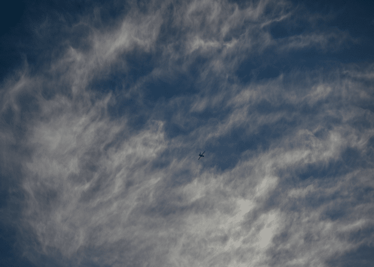 An Israeli air-force single isolated drone in the distance with partly cloudy background. This is not a photo of Israel's AI killer drones in the story.