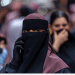 A Kashmiri Muslim woman speaks on her mobile phone in a market, ahead of Eid al-Adha, one of the most important festivals in Islam on May 25, 2026 in Srinagar, India.