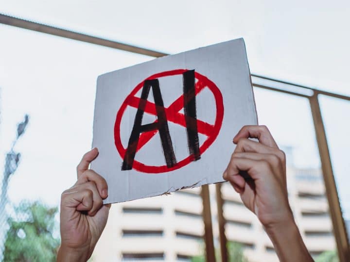 Hands holding a placard with AI crossed out SAG-AFTRA and Equity AI campaigns