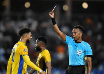 Gabon's forward #20 Denis Bouanga is shown the yellow card by Somali referee Omar Abdulkadir Artan during the Africa Cup of Nations (CAN) Group F football match between Gabon and Ivory Coast at the Grand Stadium in Marrakech on December 31, 2025. (Photo by Khaled DESOUKI / AFP via Getty Images)