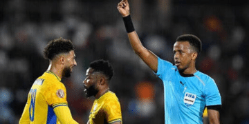 Gabon's forward #20 Denis Bouanga is shown the yellow card by Somali referee Omar Abdulkadir Artan during the Africa Cup of Nations (CAN) Group F football match between Gabon and Ivory Coast at the Grand Stadium in Marrakech on December 31, 2025. (Photo by Khaled DESOUKI / AFP via Getty Images)