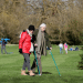 Carers Week: An older pair, one with two crutches, and the other locking their arm, walk and enjoy the spring sunshine at Mottisfont one of the National Trust parklands on 21 March 2020 in Romsey, UK