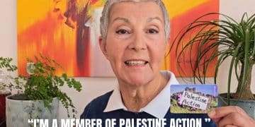A person holds a pretend Palestine Action membership card
