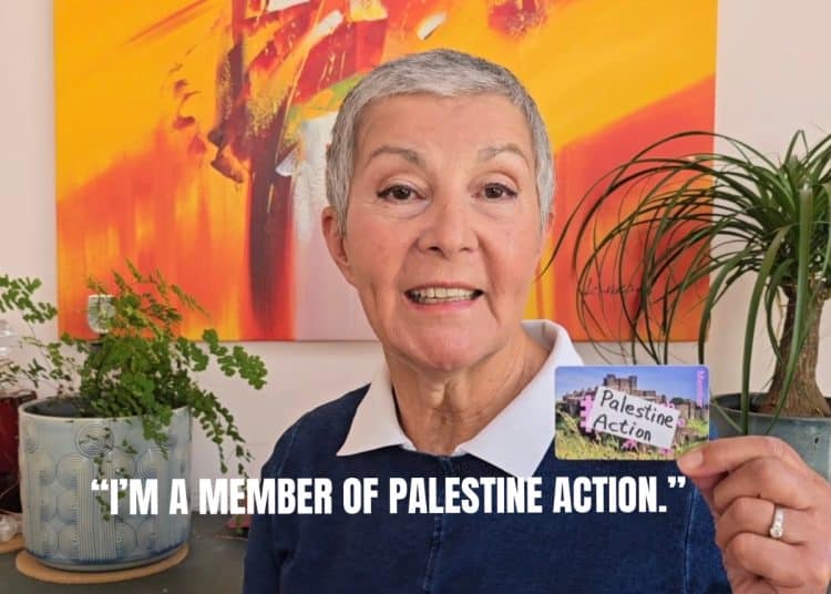 A person holds a pretend Palestine Action membership card