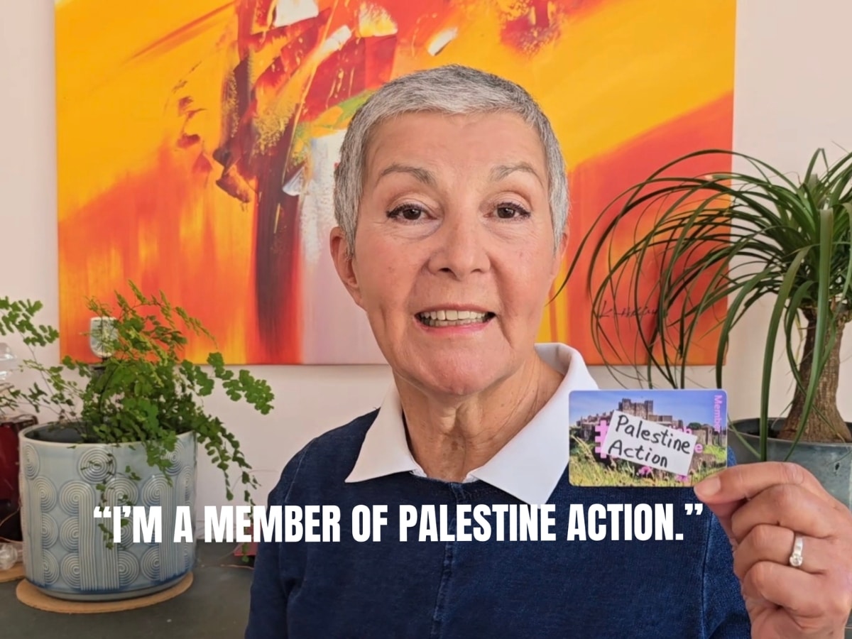 A person holds a pretend Palestine Action membership card