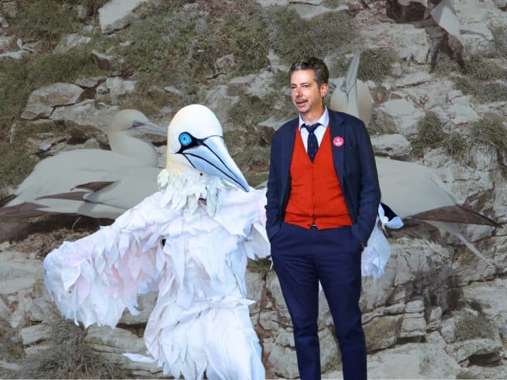 Composite image with gannets in background. In foreground, guga hunt protester Rob Pownall, in gannet costume, and Labour MP Torcuil Crichton