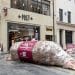 A giant model chicken, labelled as a FrankenWrap, lies on the pavement outside a branch of Pret A Manger