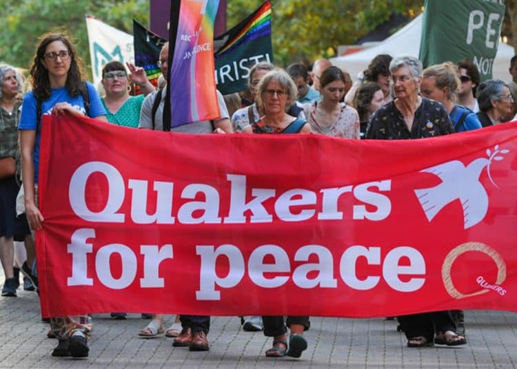Quakers hold a banner saying Quakers For Peace Quakers in Britain comment on Palestine Action ban