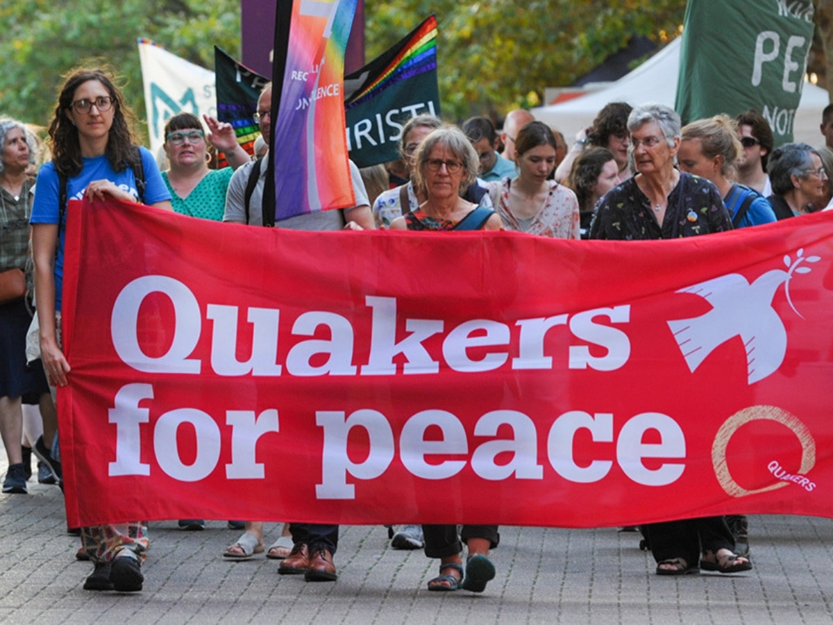 Quakers hold a banner saying Quakers For Peace Quakers in Britain comment on Palestine Action ban
