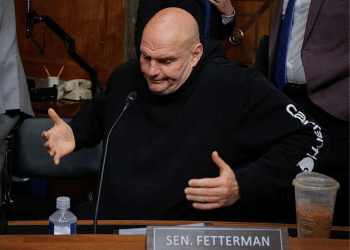 Senate Homeland Security and Governmental Affairs Committee member Senator John Fetterman shrugs after voting for Senator Markwayne Mullin to be Secretary of the Department of Homeland Security at the Dirksen Senate Office Building on Capitol Hill on 19 March 2026 in Washington, DC in the US