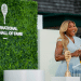 Serena Williams, looking glam in a smart tennis dress, introduces Maria Sharapova during the 2025 Induction Celebration weekend at the International Tennis Hall of Fame in Newport, R.I. on Saturday, August 23, 2025.