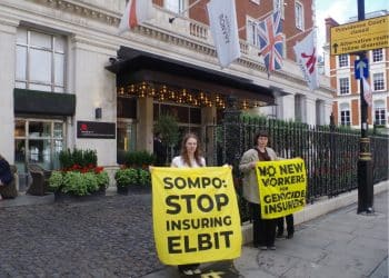 Protesters against Sompo Insurance hold banners saying: Sompo: Stop Insuring Elbit and No New Workers For Genocide Insurers